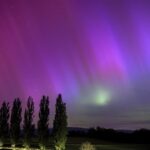 Auroras sparkle as massive solar storm strikes Earth, threatening to disrupt satellites, power grids