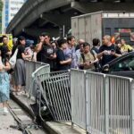 Hong Kong police searching for driver on the run after hitting railing and bus
