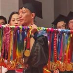 Chinese student displays 70 marathon medals at graduation after running to fund education